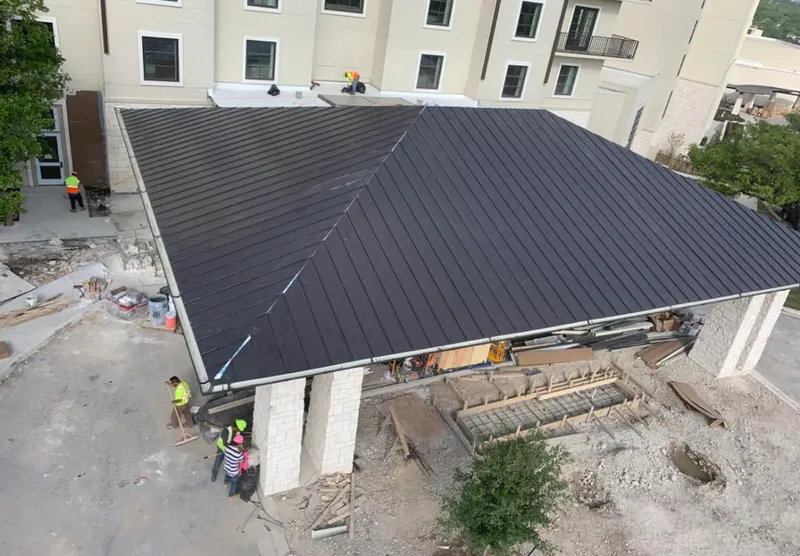 Metal roofing installation team working on a commercial building in Macon