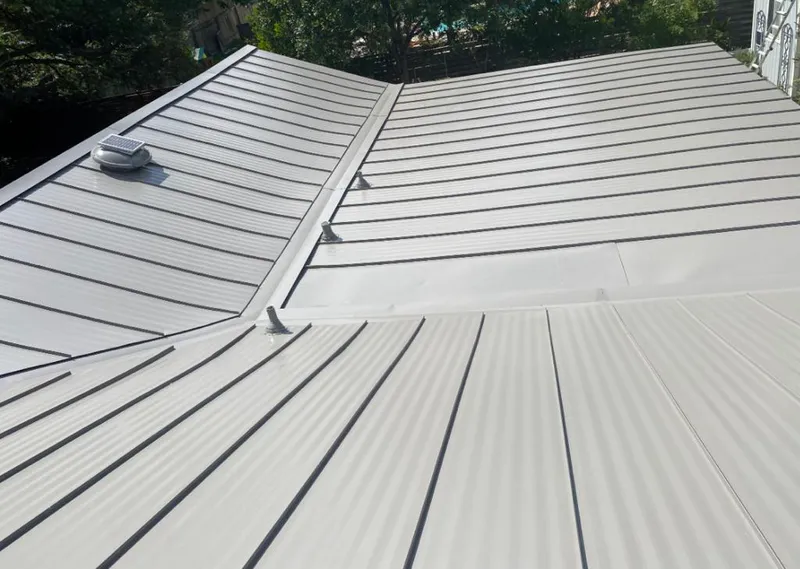 Solar attic fan installed on a metal roof for Roof Ventilation in Macon